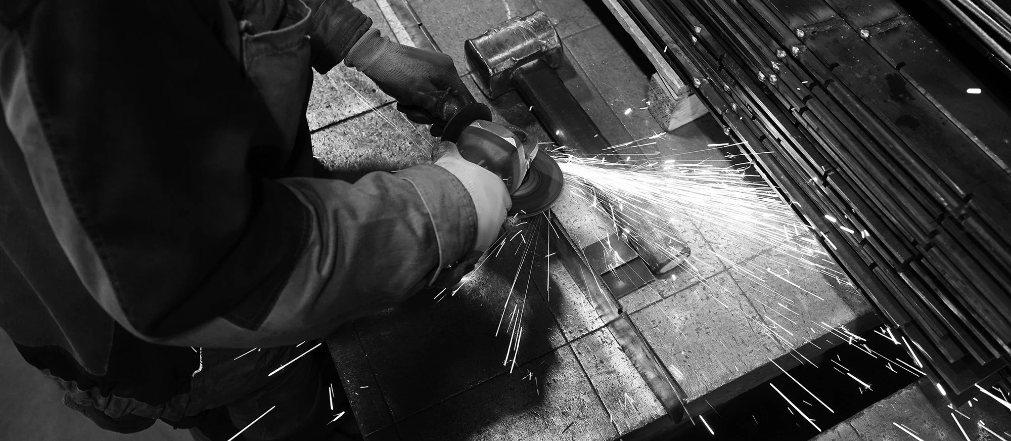 Grinding metal with sparks in the workshop